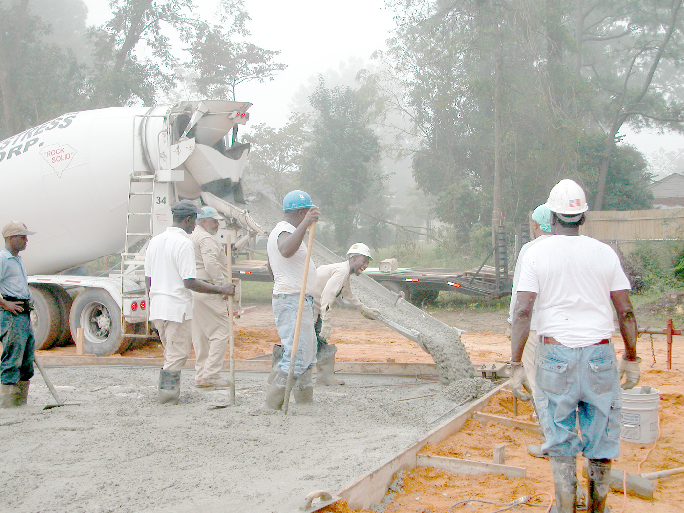 Pouring a concrete slab-on-grade foundation, which eliminates the need for a basement or subterranean crawl space entirely.