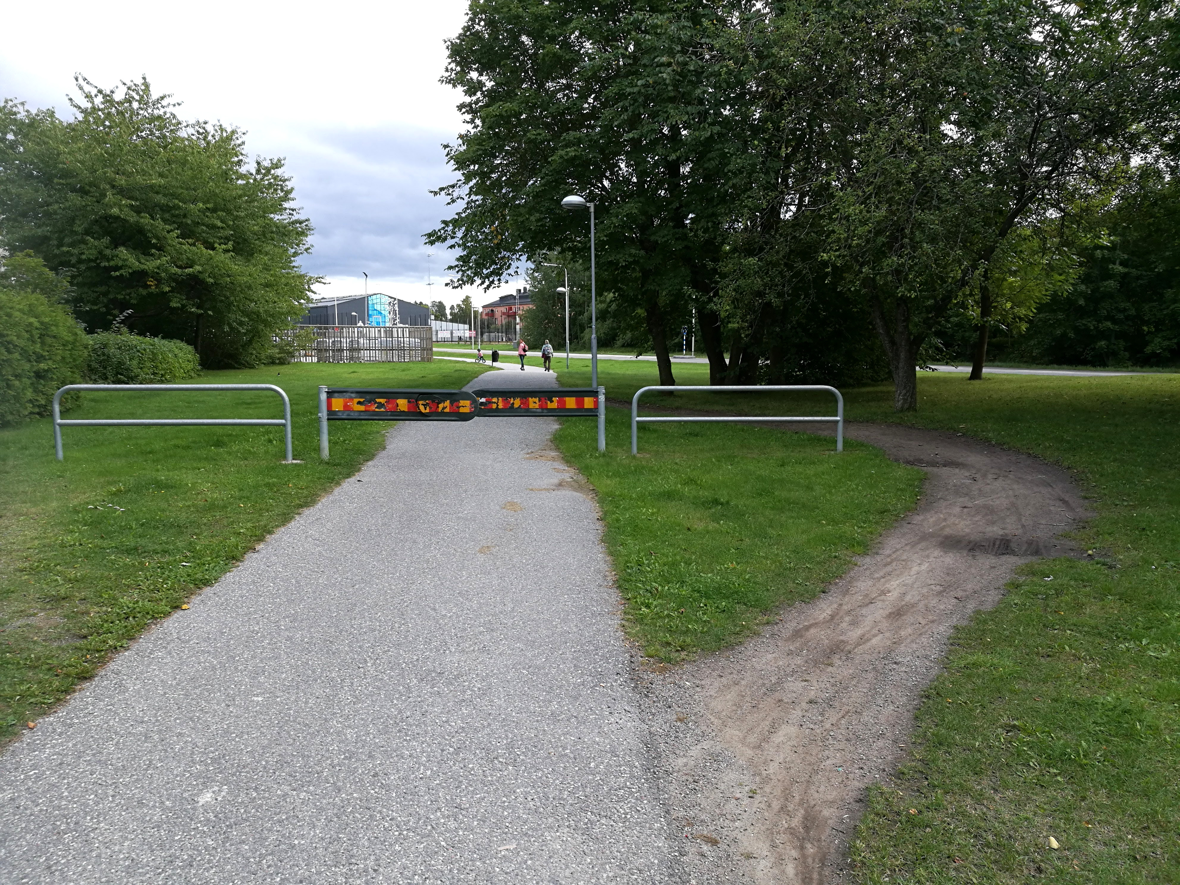 A "desire path" bypassing a physical barrier visually demonstrates the concept of the path of least resistance. In classroom management, environments must be engineered so that positive behavior is the most natural and effortless choice.