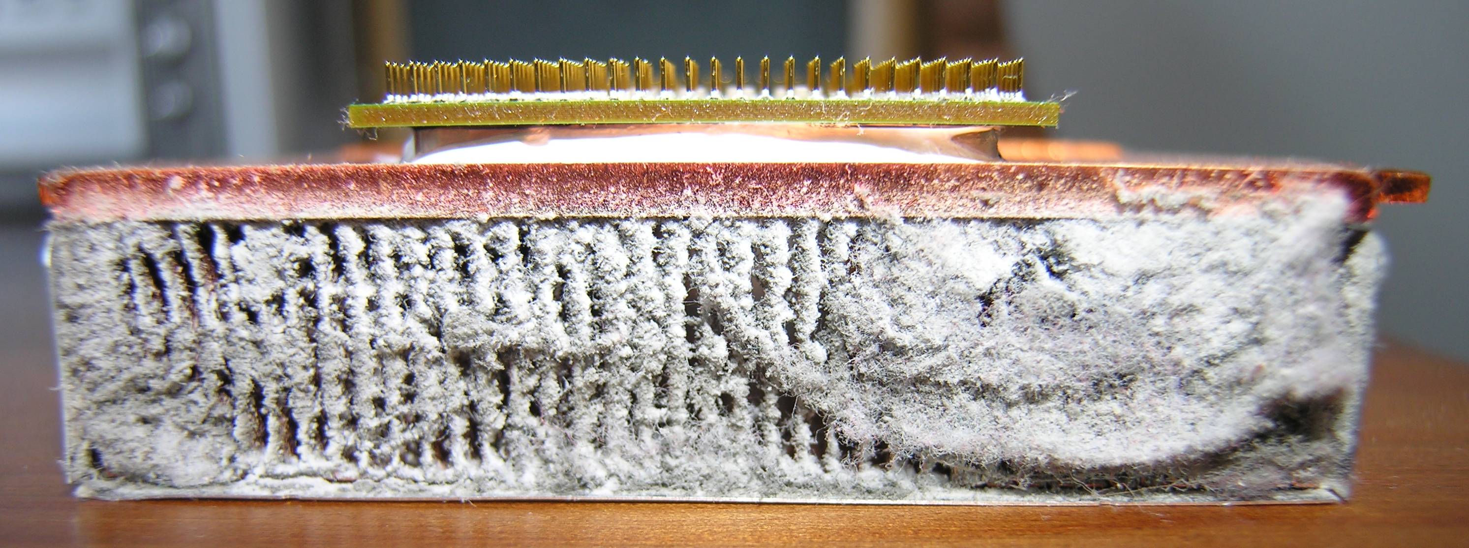 Severe dust accumulation on a CPU heatsink, a primary cause of blocked case ventilation, thermal throttling, and unexpected system shutdowns.