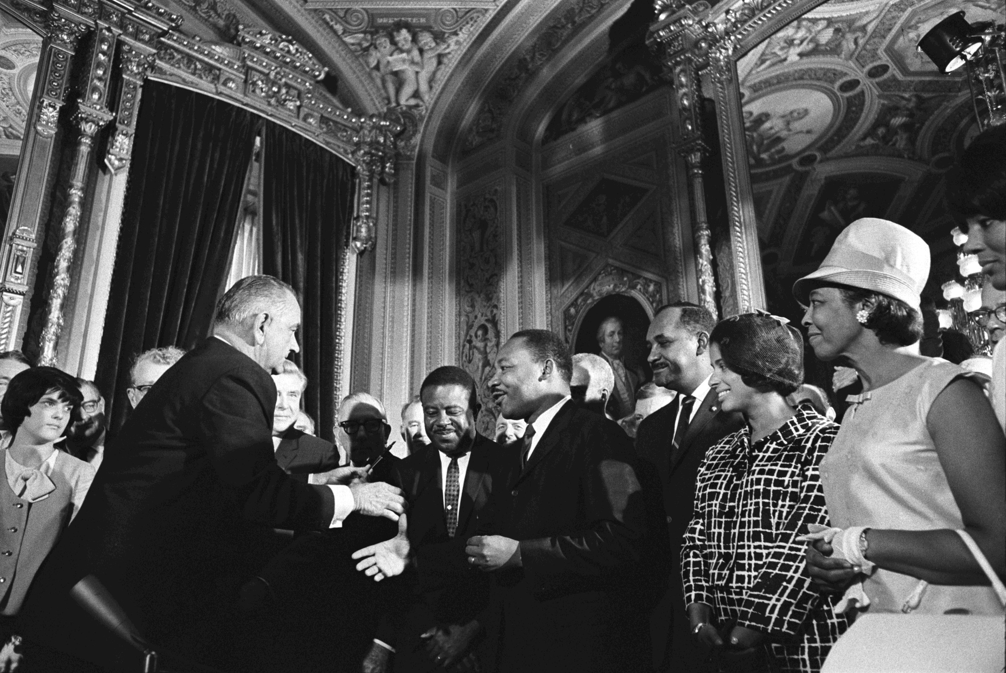 President Lyndon B. Johnson meets with Dr. Martin Luther King Jr. and Rosa Parks at the historic signing of the Voting Rights Act on August 6, 1965.
