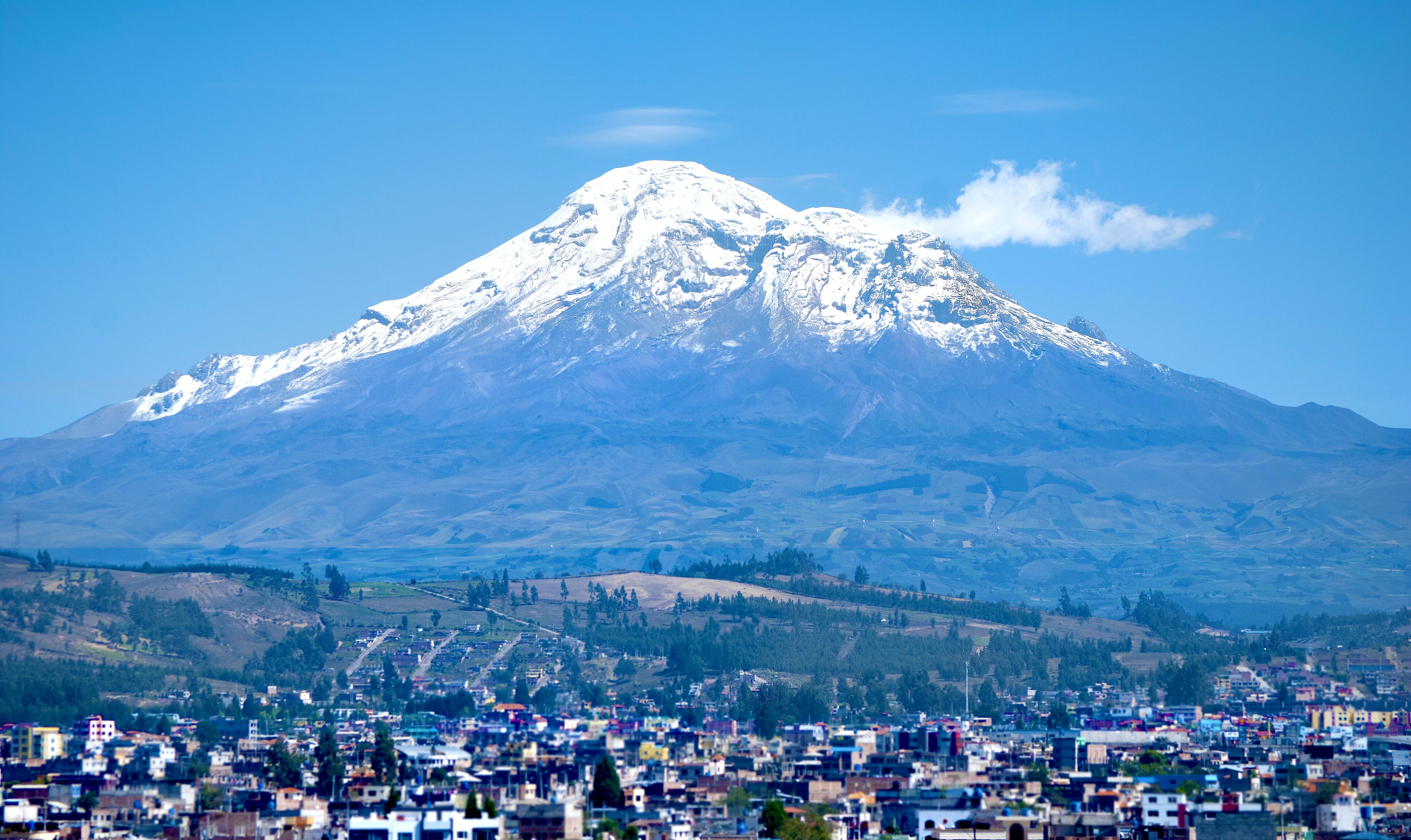 Despite being located right near the equator, Mount Chimborazo in Ecuador retains glaciers year-round due to the environmental lapse rate, which steadily cools the atmosphere at higher elevations.