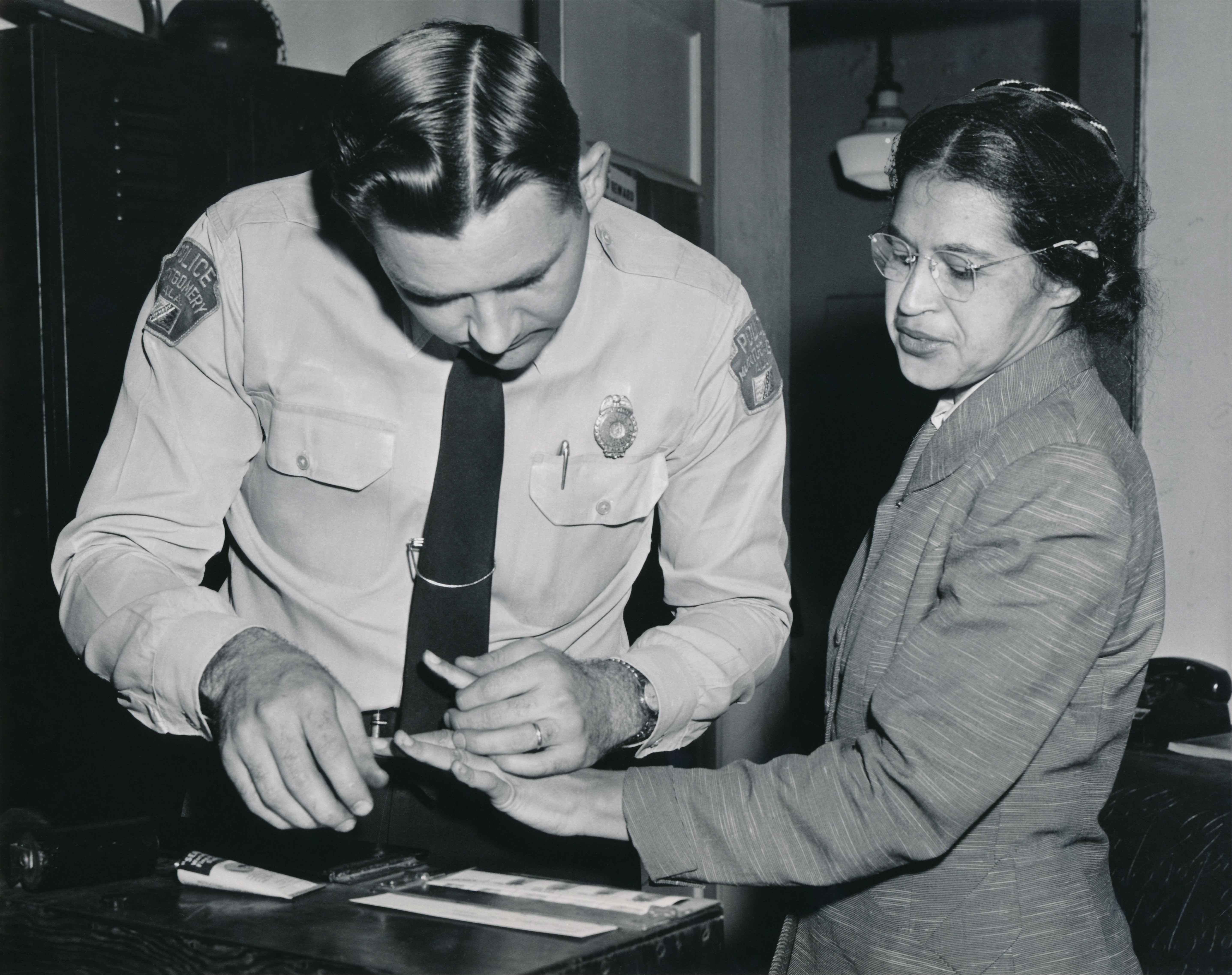Rosa Parks being fingerprinted following her arrest for refusing to surrender her bus seat, an act of civil disobedience that catalyzed the Montgomery Bus Boycott.
