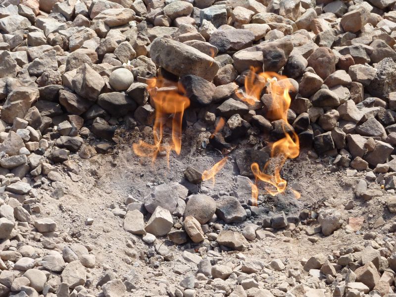 Natural gas seeping and burning directly from the ground. Section 242 mandates disclosures to protect buyers from the severe fire and environmental hazards posed by historic, uncapped gas wells often found in upstate and western New York.