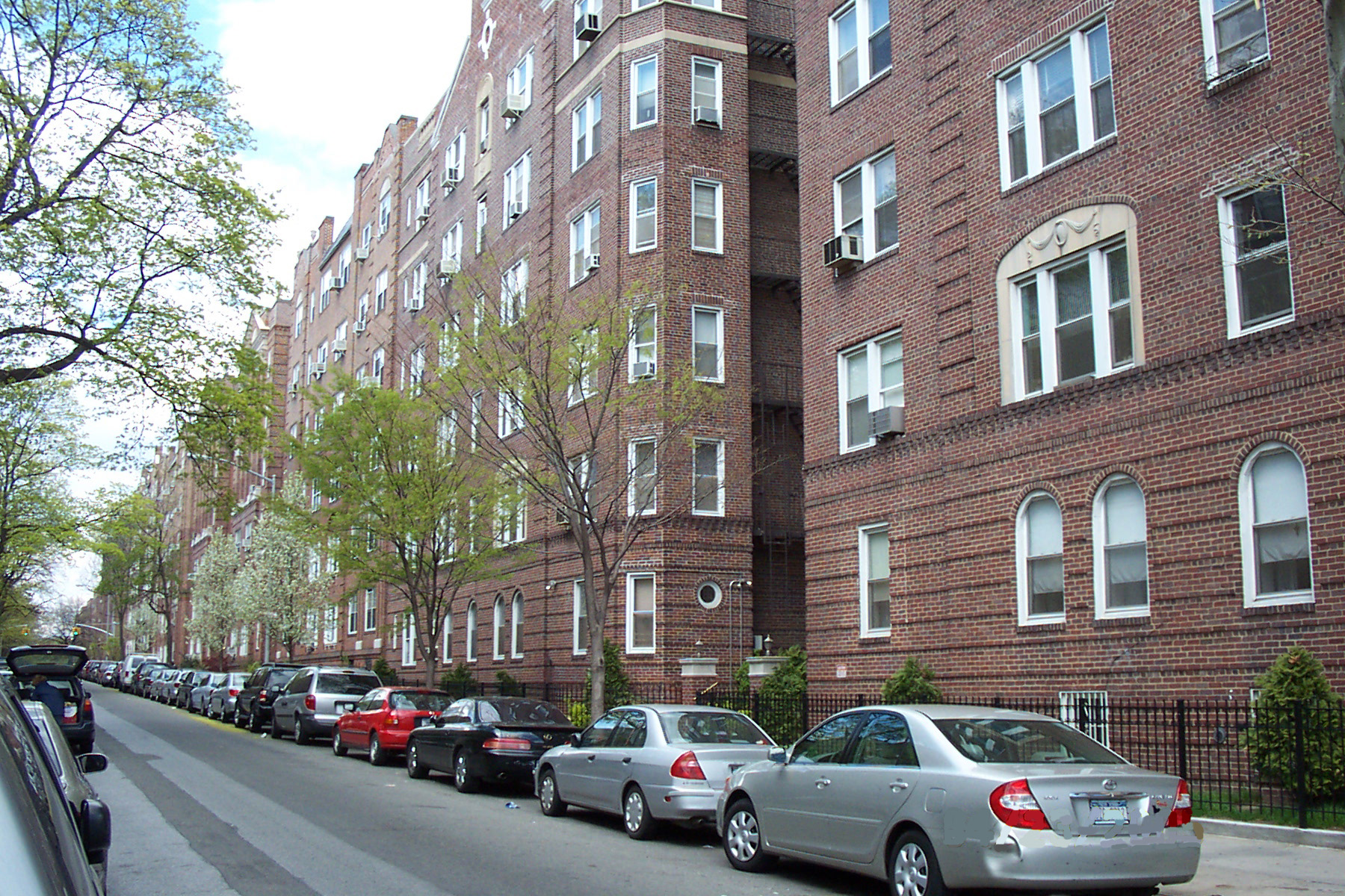 A typical residential street in Queens, New York. In areas like this, invisible geographic boundaries dictated by the Department of State can separate legal marketing practices from criminal misdemeanors.