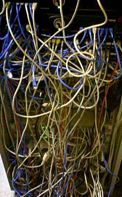 Severely neglected cable management, often referred to as "cable spaghetti," creates dangerous tripping hazards that threaten the physical safety of IT professionals and the integrity of the hardware.