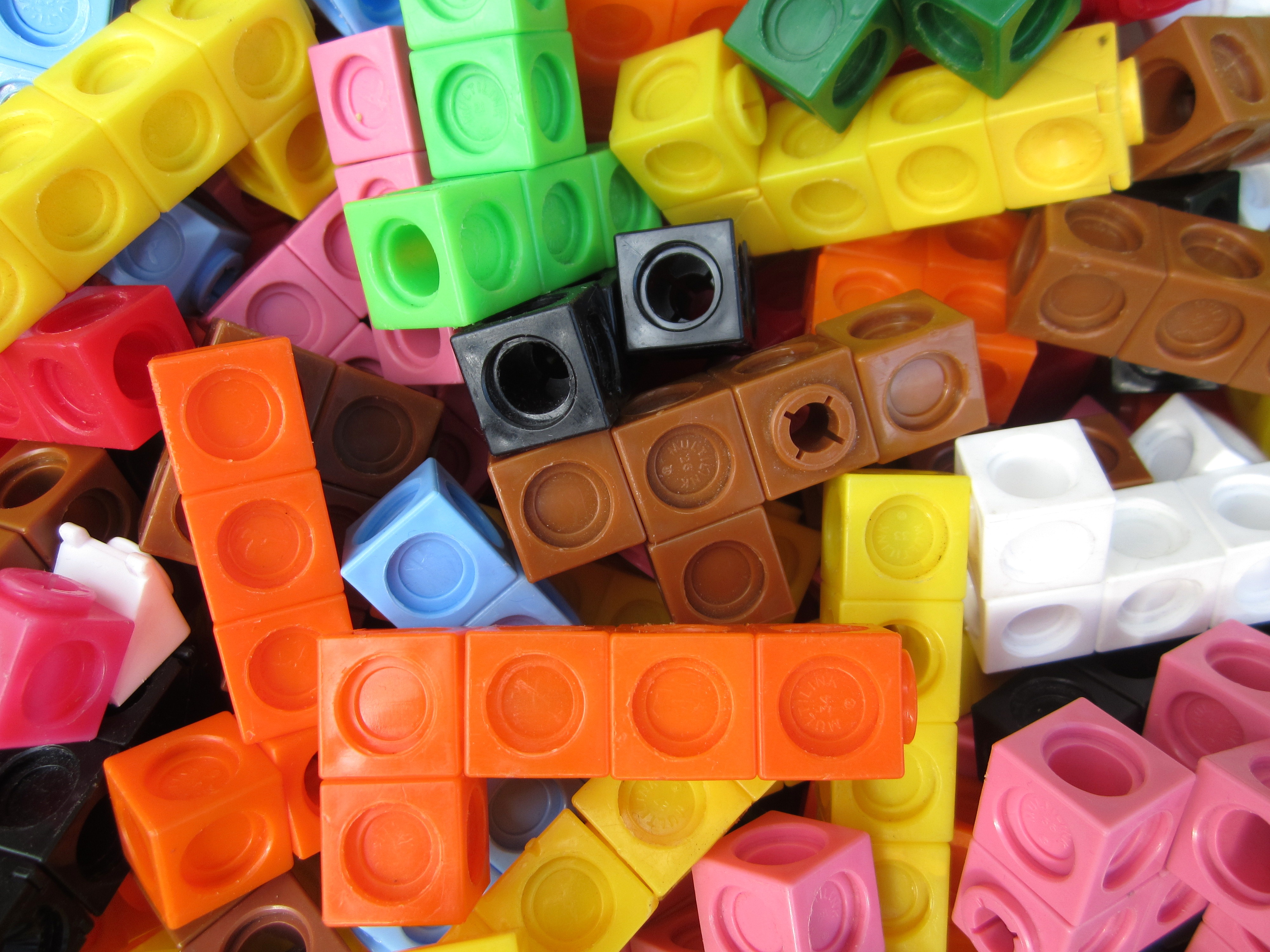 Interlocking linking cubes are a common physical manipulative used to provide an alternative, concrete representation of abstract math concepts.