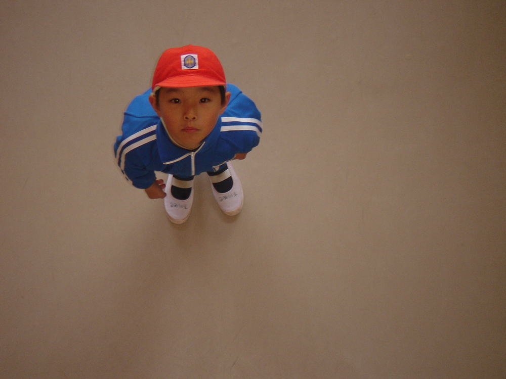 By positioning the camera above the subject, a high-angle shot isolates characters within their environment and emphasizes vulnerability.