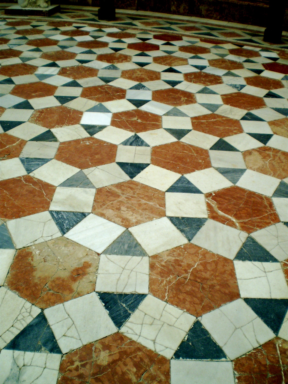Tessellation, or tiling, visually demonstrates the concept of area by completely covering a surface with geometric units without leaving gaps or allowing overlaps.