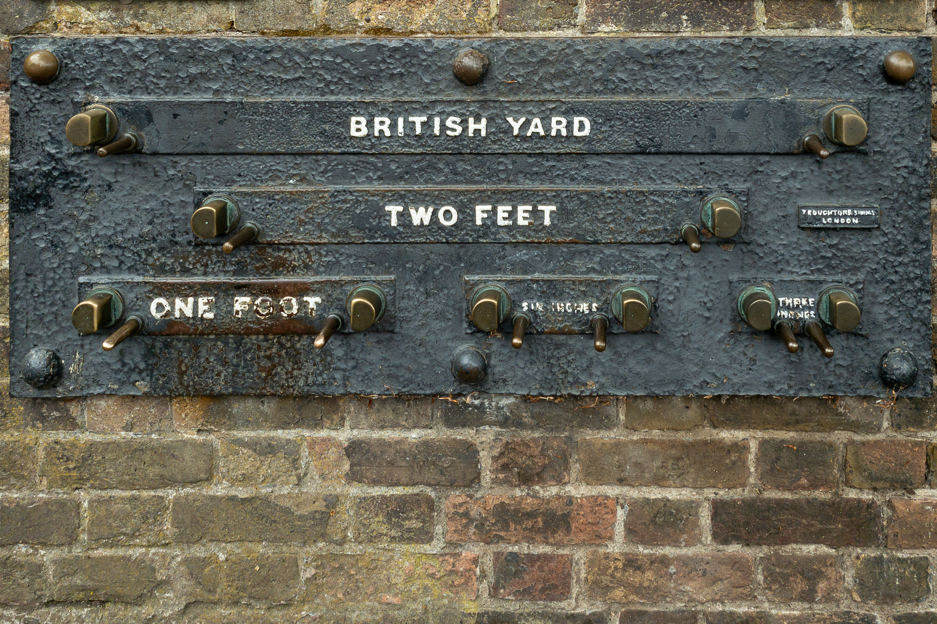 Public measurement standards for the U.S. Customary and British Imperial systems, such as these in Greenwich, historically provided a physical reference for lengths like the yard, foot, and inch.