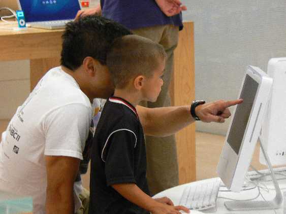 A parent and child demonstrate joint attention by simultaneously focusing on the same target, a key social-communication milestone that is often delayed in atypical development.