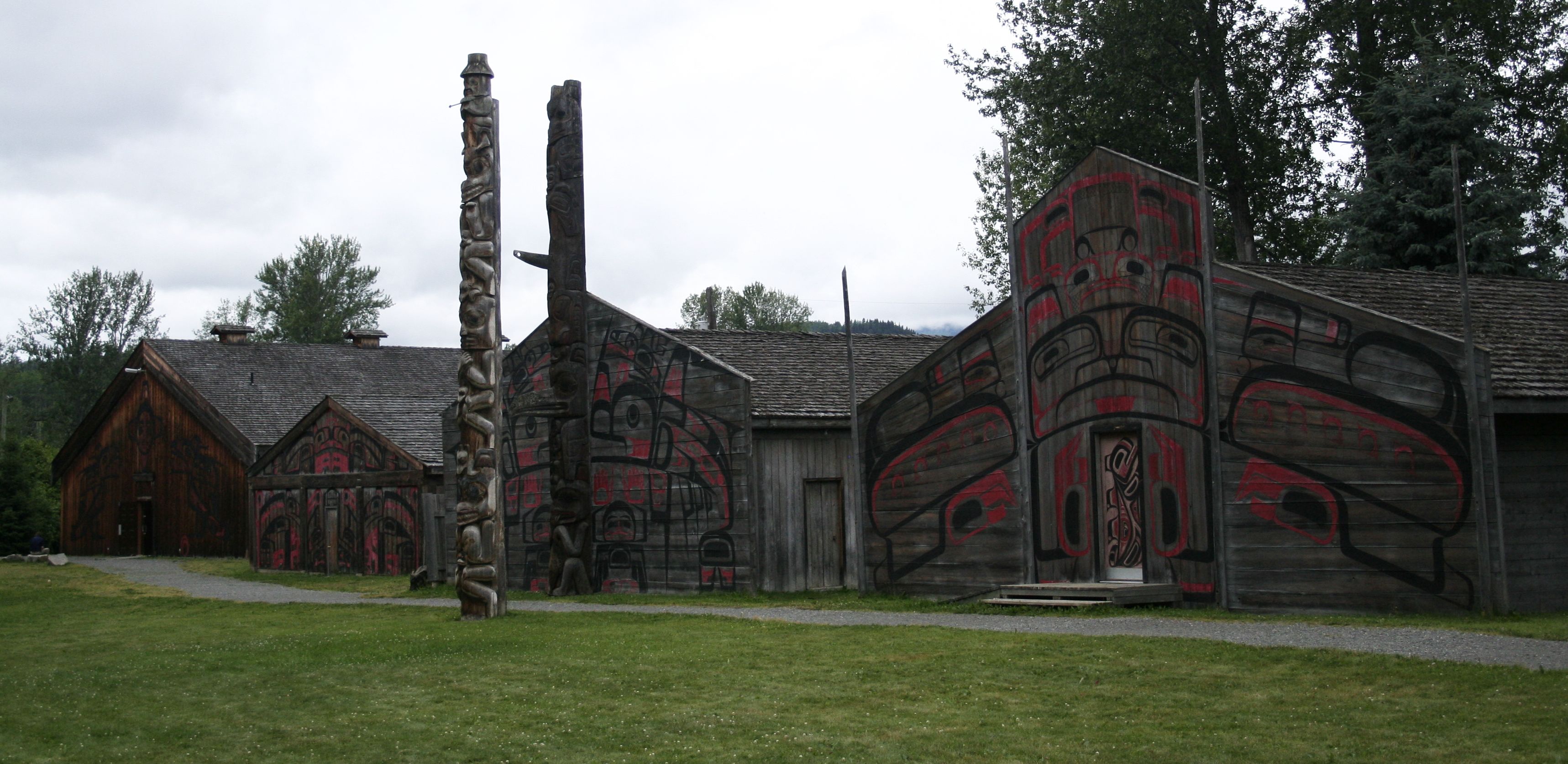 'Ksan Historical Village showcasing traditional wooden longhouses and intricately carved totem poles, built entirely from the region's abundant cedar forests.