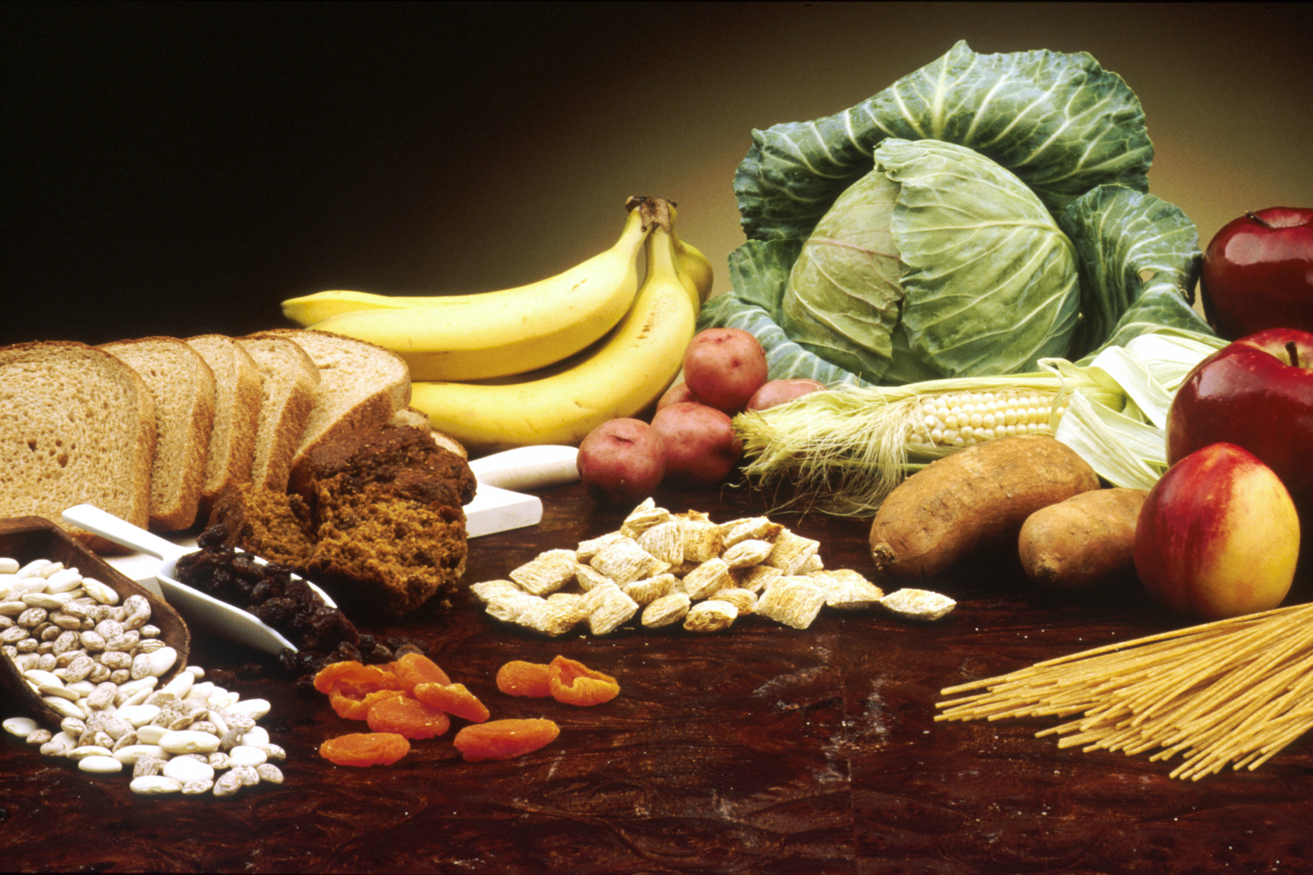 Foods naturally rich in dietary fiber, such as fruits, vegetables, and grains, are essential in bowel training programs to provide optimal fecal bulk and promote healthy peristalsis.