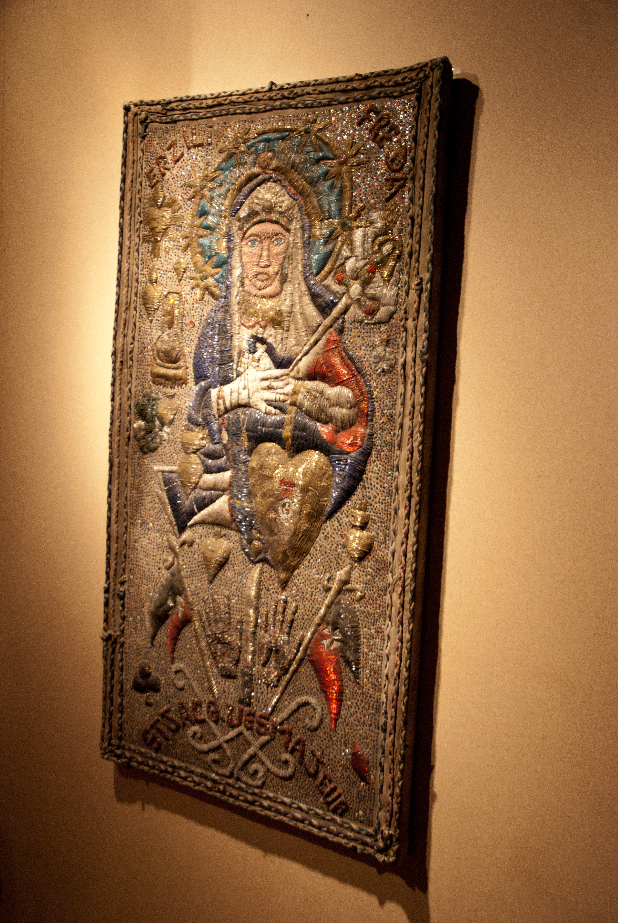 A Haitian Vodou drapo (banner) depicting a Roman Catholic saint. This is a primary example of cultural syncretism, where marginalized people blended imposed European religious iconography with traditional African belief systems to preserve their spiritual identities.