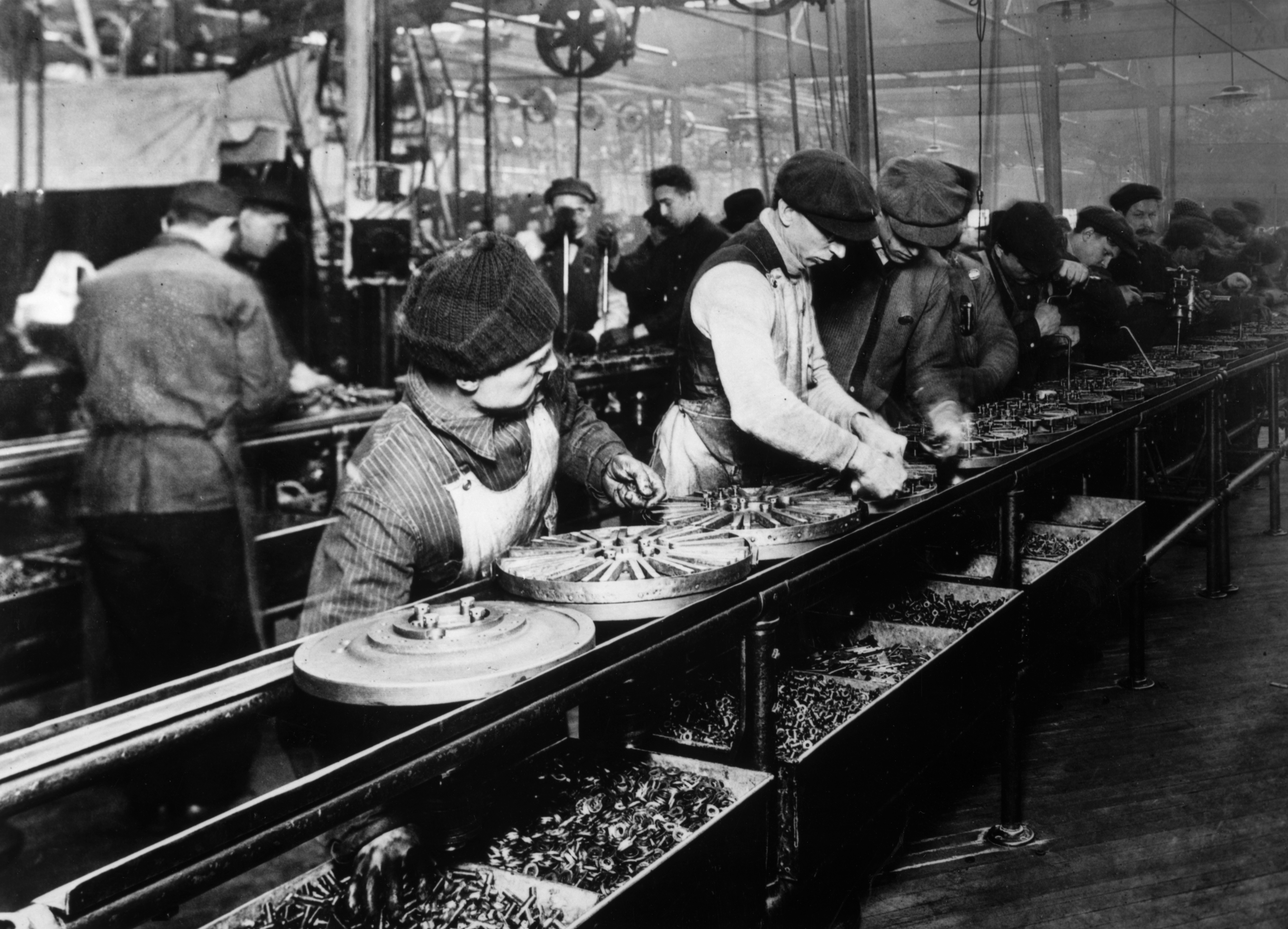Workers on the Ford assembly line in 1913, a manufacturing innovation that drastically reduced the time and financial cost required to produce industrial goods.
