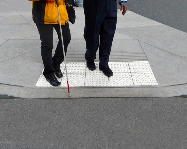 While accessible public infrastructure—such as tactile paving for visually impaired individuals—is essential for physical integration, dismantling invisible social stigmas is equally necessary for true community inclusion.