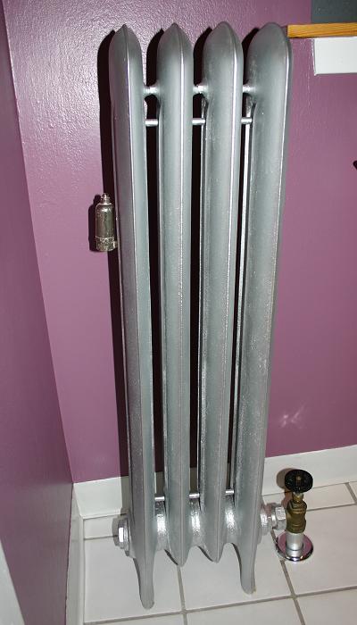 A traditional cast iron steam radiator. Unlike hydronic systems, these utilize the natural pressure of steam for distribution and require specialized air vents.
