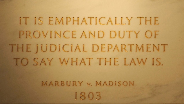 An inscription on the wall of the Supreme Court Building quoting Chief Justice John Marshall's decision in Marbury v. Madison, which cemented the power of judicial review.