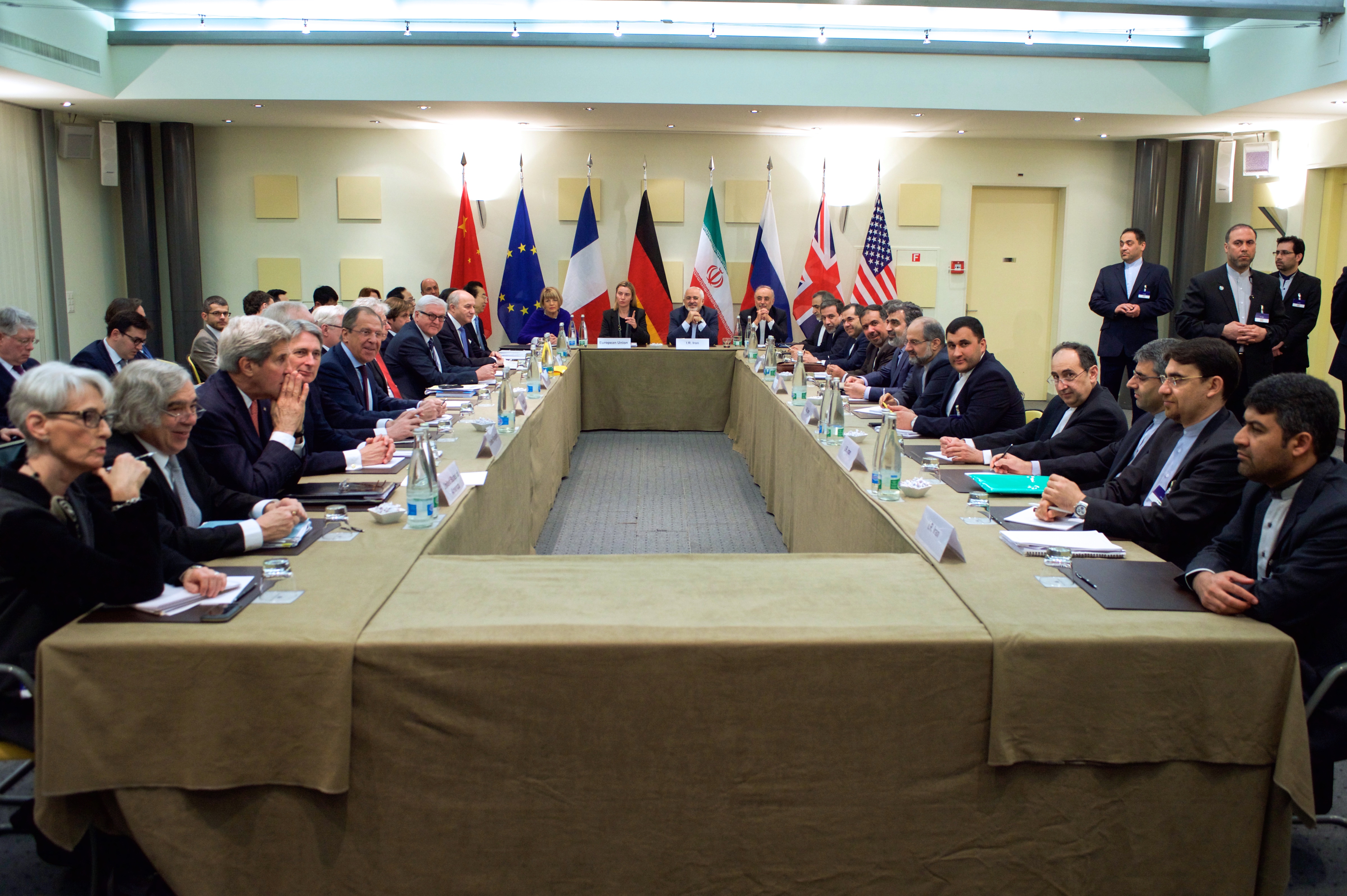 Representatives negotiating directly around a table (Iran nuclear talks, Lausanne, 2015) — negotiation needs no third party at all, and is usually the first, cheapest step tried before any formal ADR process.
