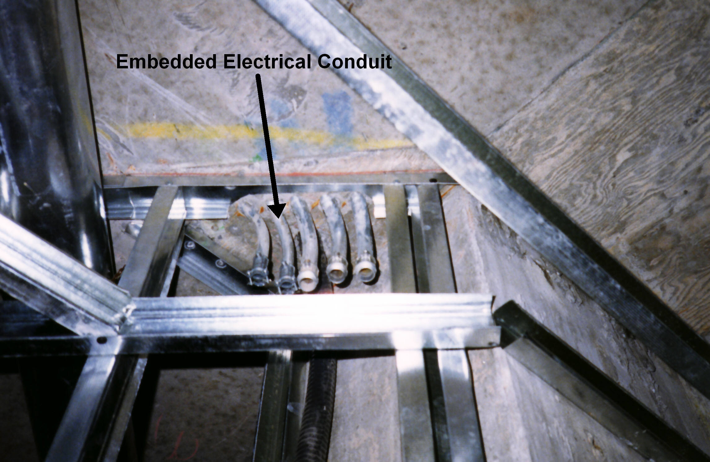 Rigid electrical conduit physically isolates and protects electrical wiring from impact. Unlike residential Romex, conduit is standard in commercial construction to prevent accidental damage to live wires.