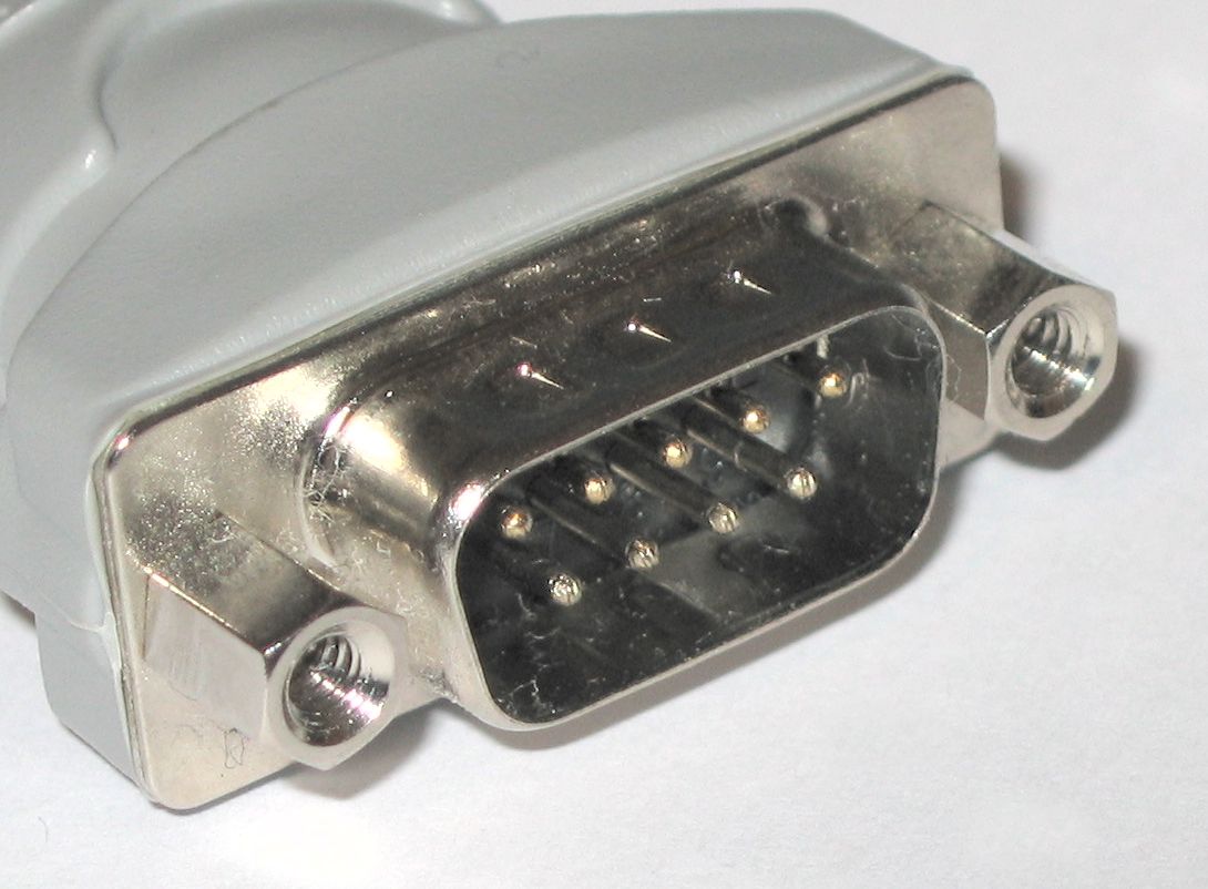 The 9-pin DB-9 (more accurately DE-9) connector is the standard physical interface for RS-232 serial communication, commonly used for out-of-band management on core network devices.