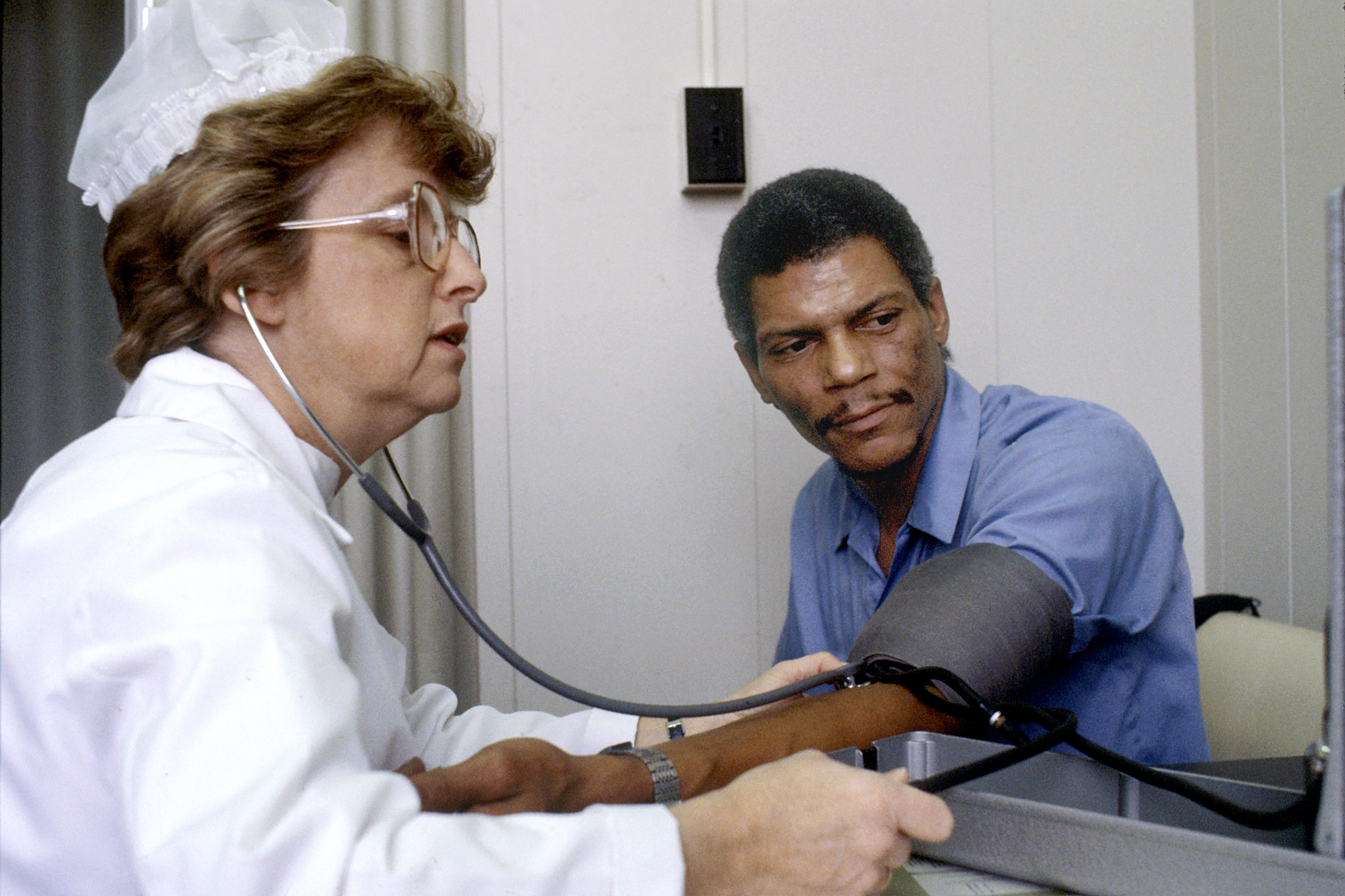 A nurse taking a patient's blood pressure. While measuring blood pressure is a routine task that can be delegated, the delegating RN retains full accountability for any resulting clinical decisions.