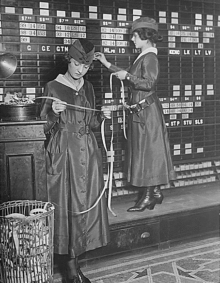 Watching a stock's daily ticker tape, as these investors are doing in 1918, provides only surface-level price momentum rather than true fundamental value.