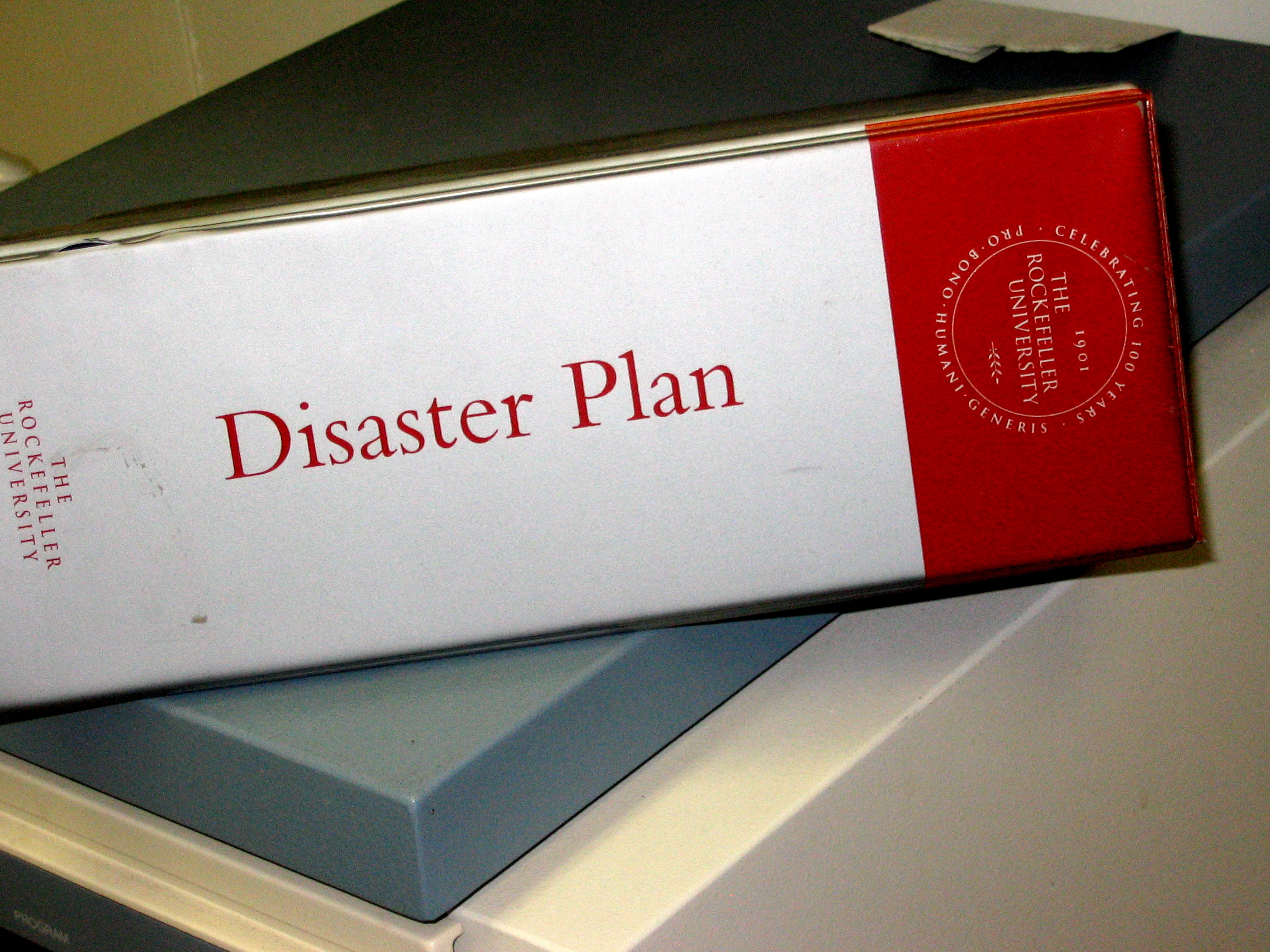 A physical disaster plan binder in a facility. Nurses must know the exact location of hard-copy protocols like this to ensure operations continue even during severe power or network outages.