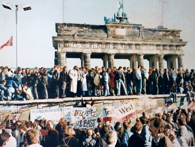 The fall of the Berlin Wall in November 1989, symbolizing the impending collapse of communist regimes across Eastern Europe.