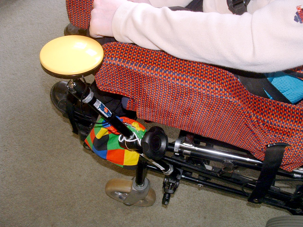 An adaptive switch device allows students with severe physical or motor impairments to independently operate appliances, exemplifying the principle of partial participation.