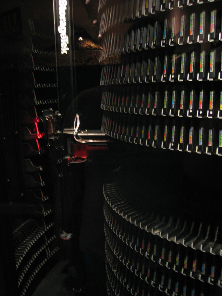 A traditional physical tape library. AWS Storage Gateway's Tape Gateway allows enterprises to permanently eliminate these localized robotic systems, replacing them with virtual tape libraries backed by Amazon S3 Glacier for infinite scalability.