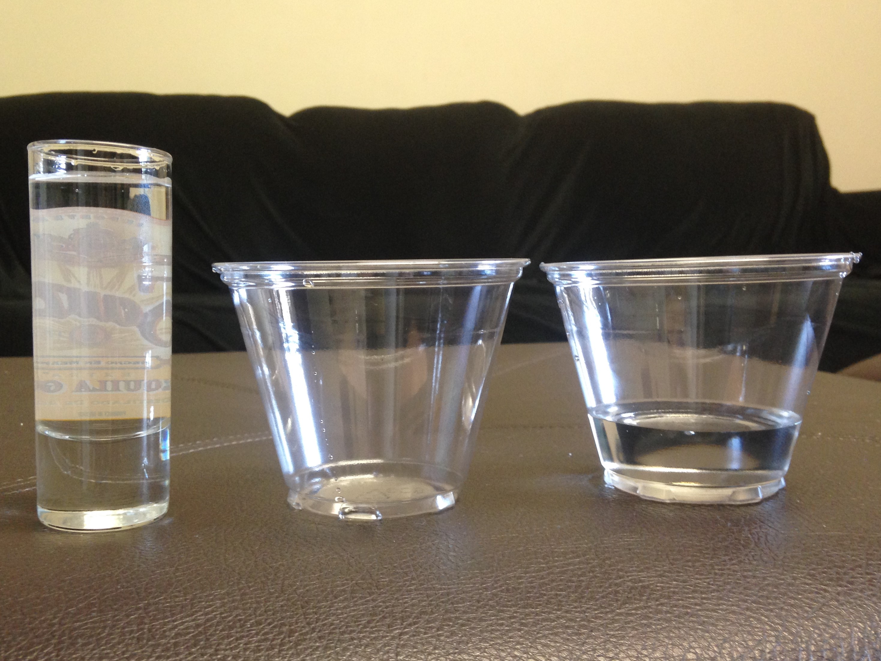 Piaget's conservation of volume task reveals that children naturally assume a taller, narrower container holds more liquid than a wider, shorter one, even when the amounts are identical.