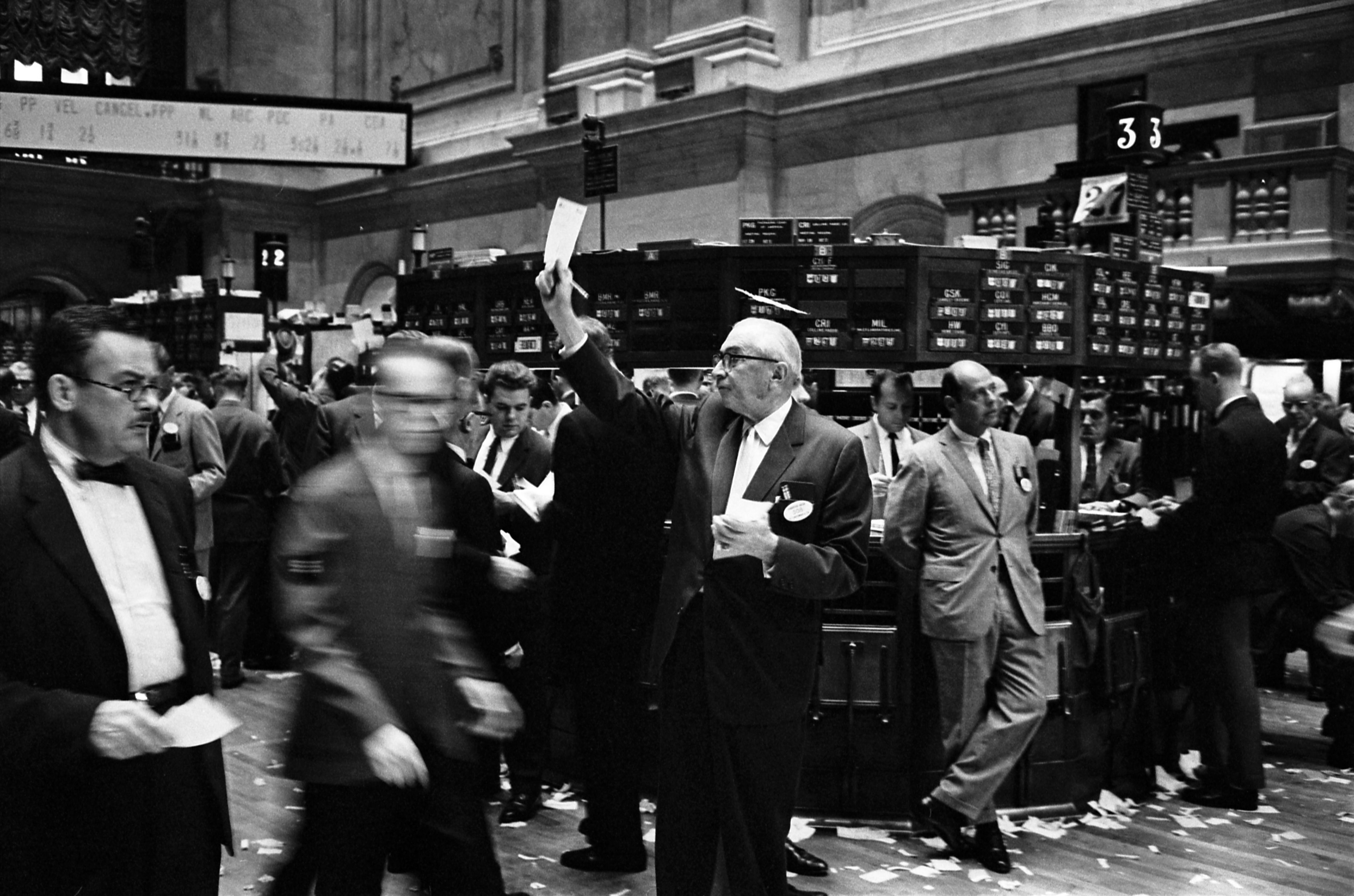Human floor brokers, pictured here at the New York Stock Exchange in 1963, manage 'Not Held' orders by using their professional judgment to time the market for the best price.