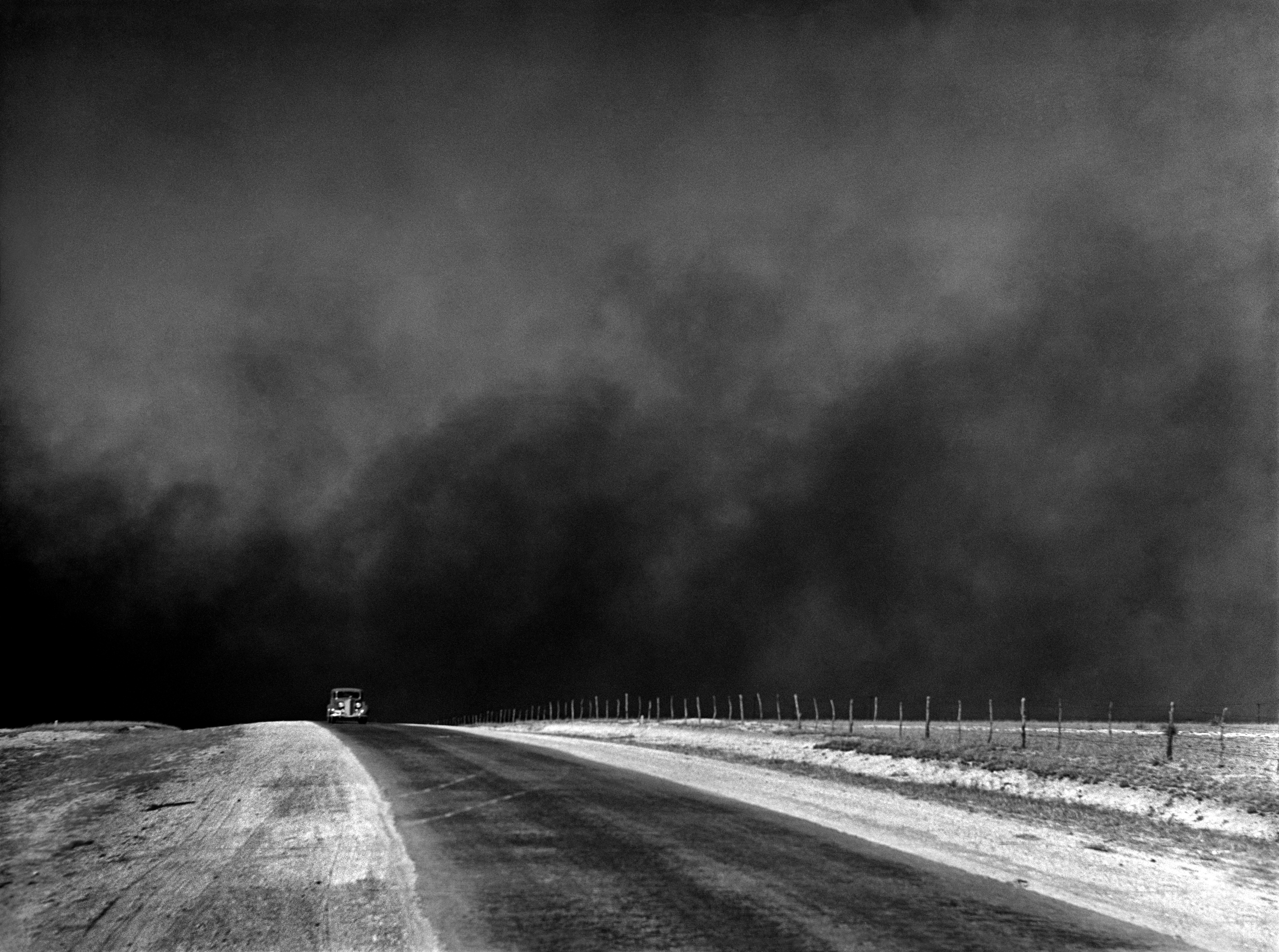 A massive "black blizzard" dust storm rolling over the Texas Panhandle in 1936, the devastating ecological result of severe drought combined with decades of deep plowing and poor soil management.