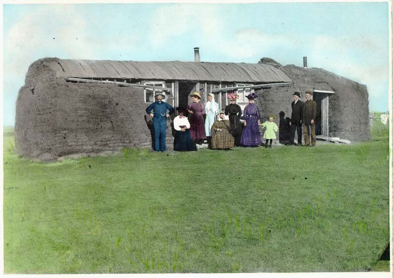 A 1900s sod house built by settlers on the North American plains. In regions lacking timber, humans adapted to geographic scarcity by constructing vernacular architecture out of the earth itself.