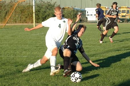 A slide tackle in football — the kind of forceful but sanctioned contact players are taken to consent to within the rules, though Condon v Basi confirms a duty not to act with reckless disregard for a fellow player's safety.