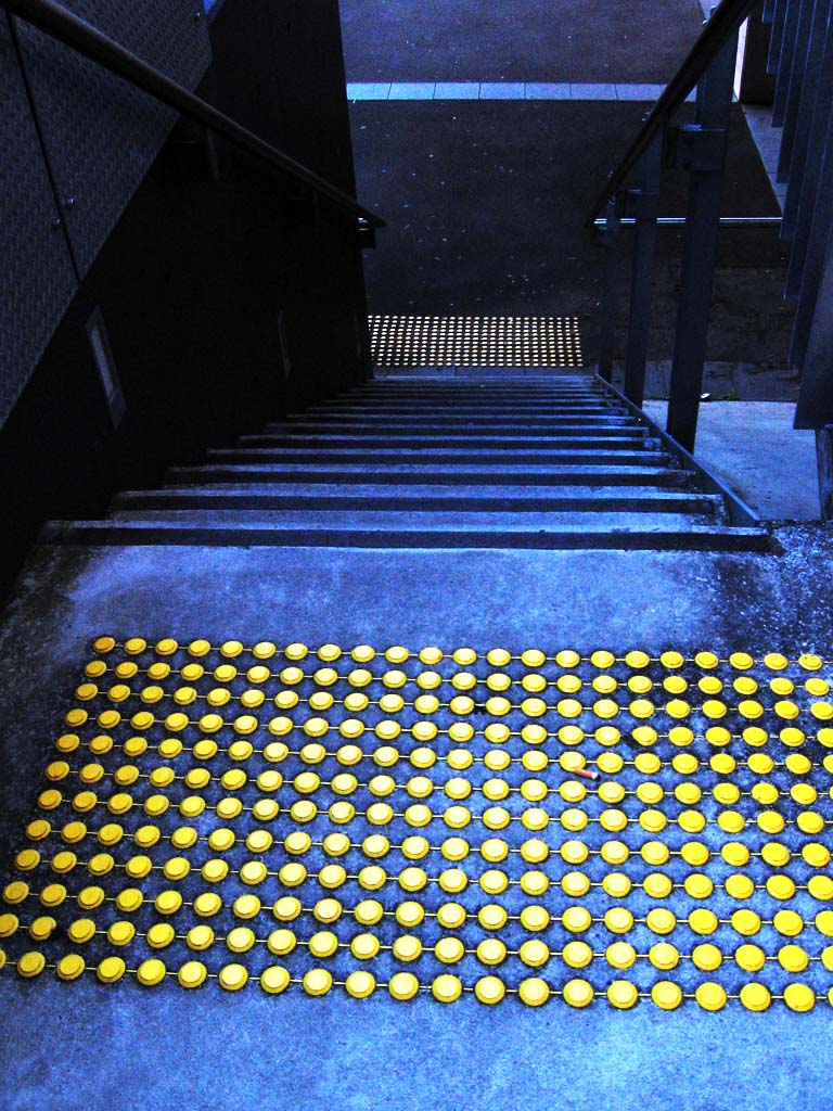 Tactile markings on a staircase. Because children with deaf-blindness cannot rely on distance senses like sight and hearing, they require highly specialized tactile and environmental scaffolding to safely navigate their surroundings.