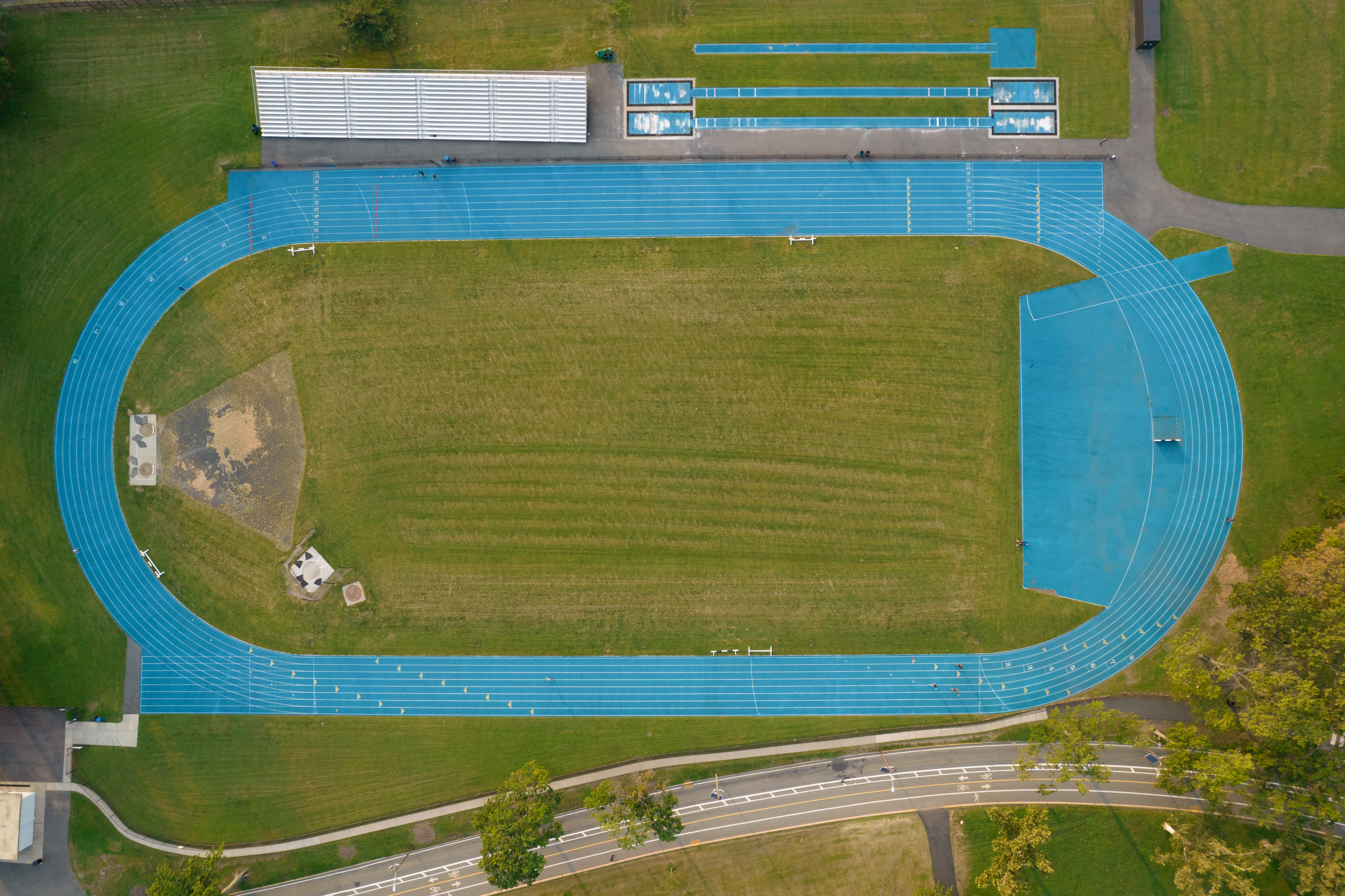 A standard running track is a classic composite figure, mathematically consisting of a central rectangle capped by two semicircles at its ends.