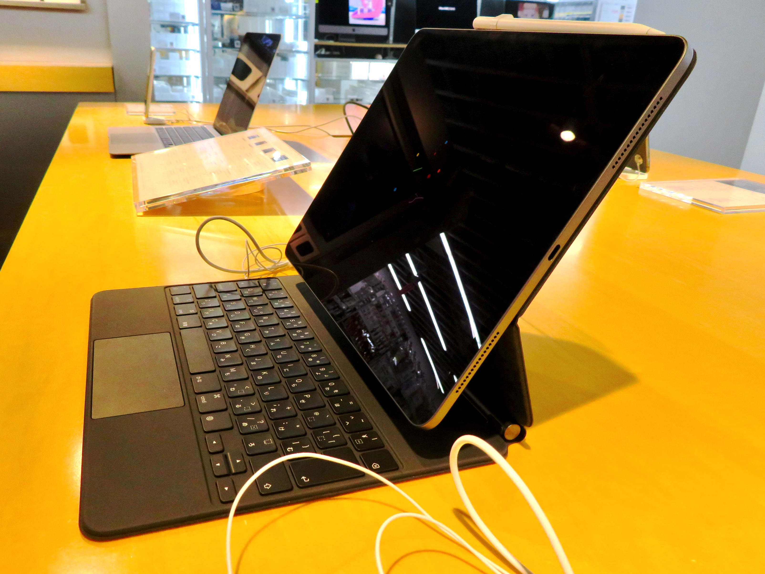 An iPad utilizing iPadOS, demonstrating advanced multi-tasking capabilities, external keyboard integration, and cursor support intended to mimic workstation productivity.