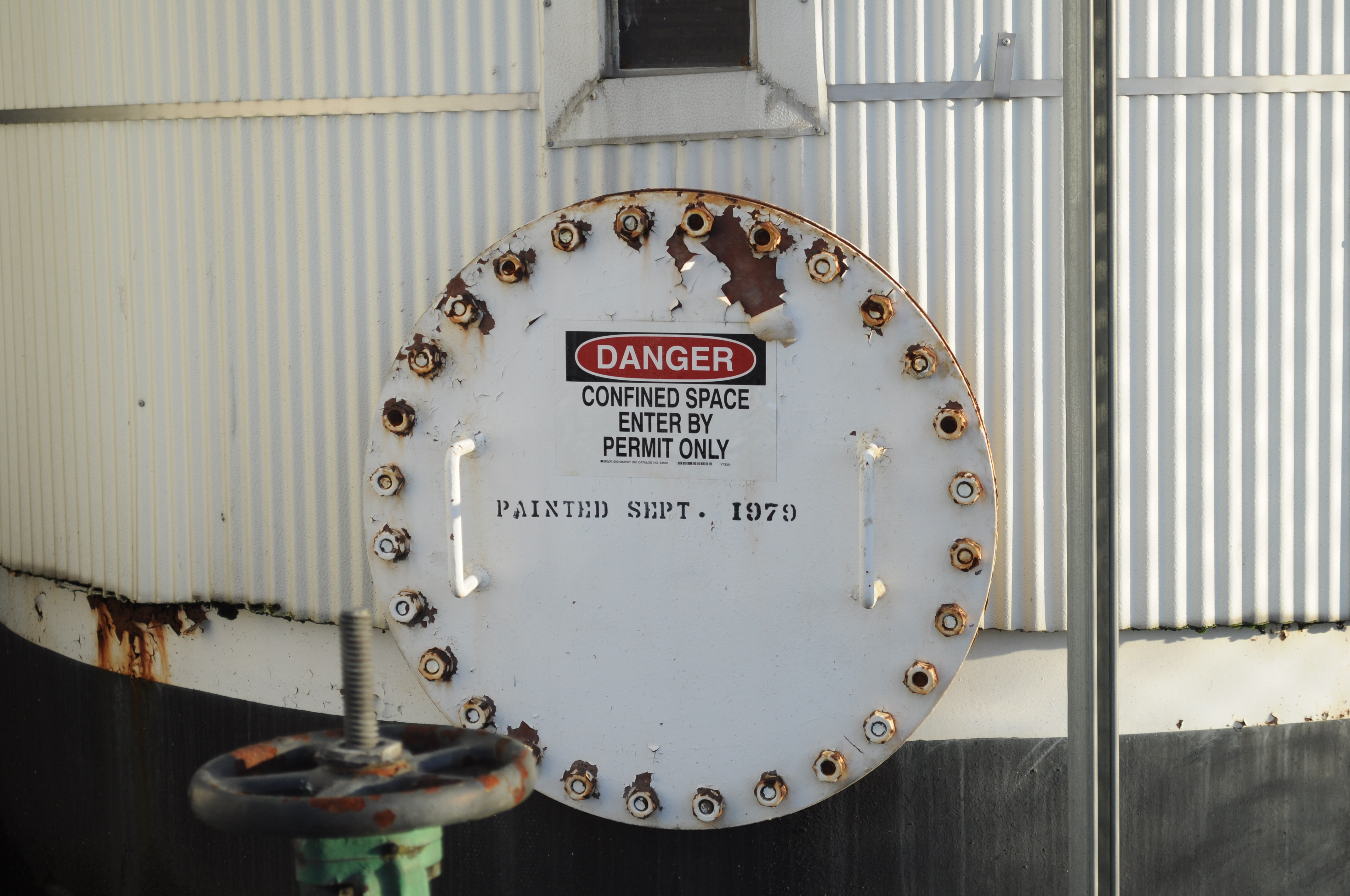 While industrial confined spaces feature explicit warning signs, residential real estate hazards—such as attics, basements, and walk-in closets—require the agent to proactively identify single-exit rooms and avoid entering them with clients.