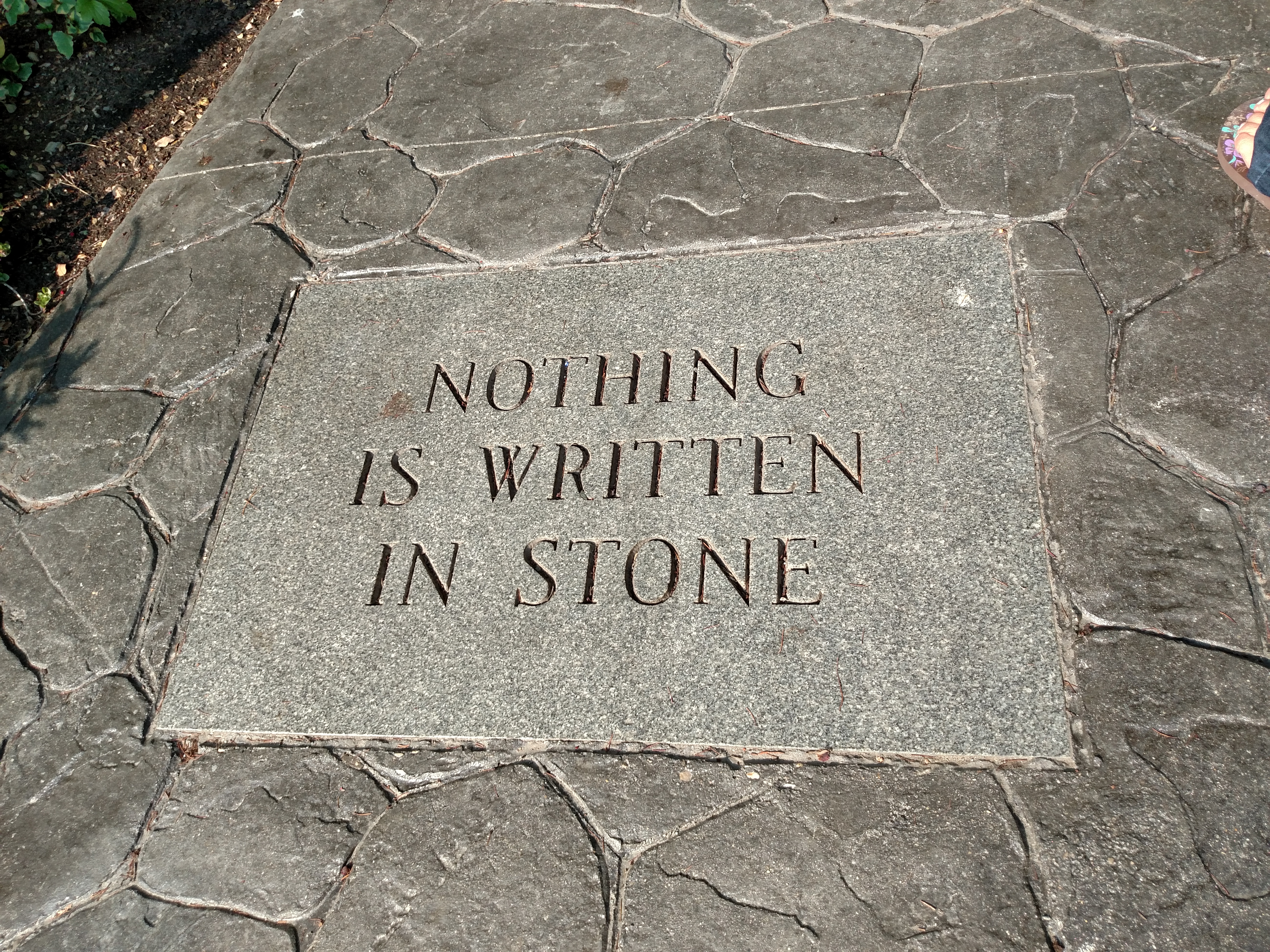 A literal carving of the phrase "nothing is written in stone." This is a perfect example of situational irony, which occurs when the physical reality of a situation directly contradicts the expected outcome or literal statement.