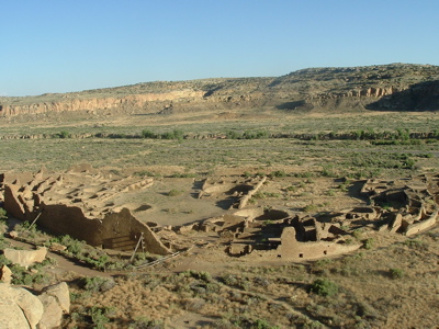 Aerial view of the Ancestral Puebloan ruins at Chaco Canyon, highlighting the massive, multi-story masonry and adobe structures perfectly adapted to regulate temperature in the arid desert climate.