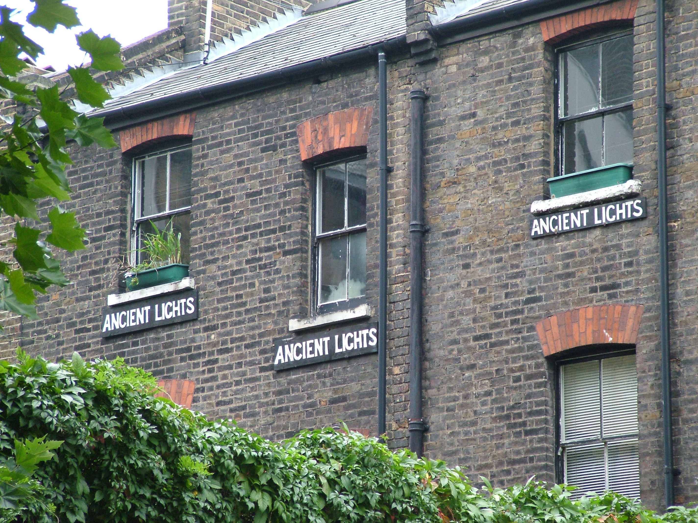 "Ancient Lights" signs in Clerkenwell, London — a historical practice by property owners asserting a right to light against neighbouring building works, the long-recognised exception to the rule against new negative easements.