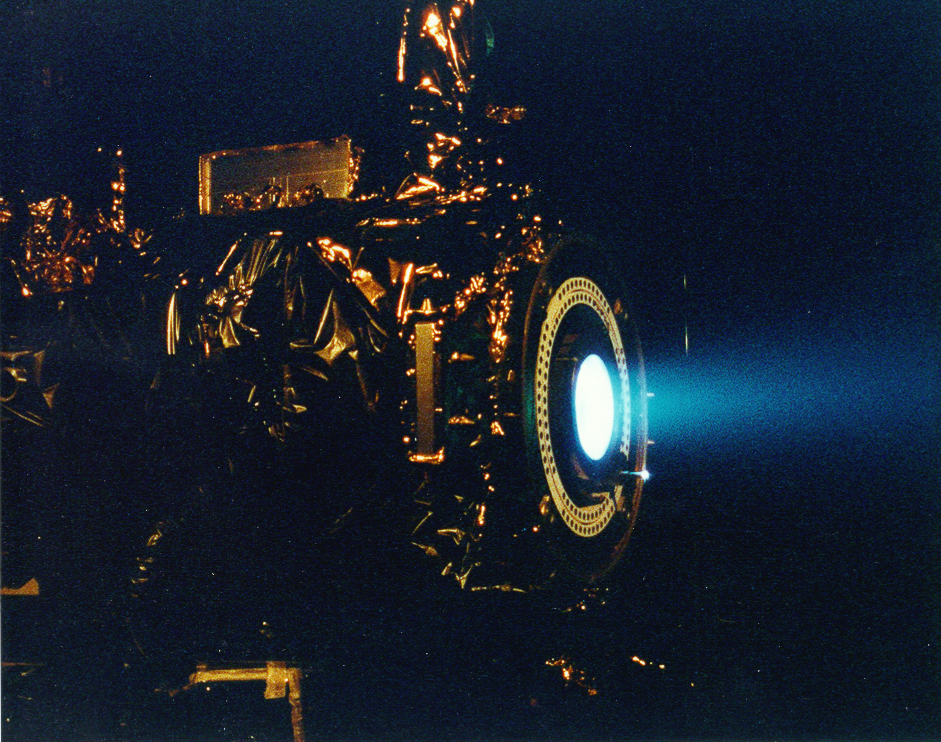 A spacecraft thruster undergoing a test firing. In project management, as in orbital mechanics, uncontrolled course corrections by individual team members can lead to catastrophic project failure.