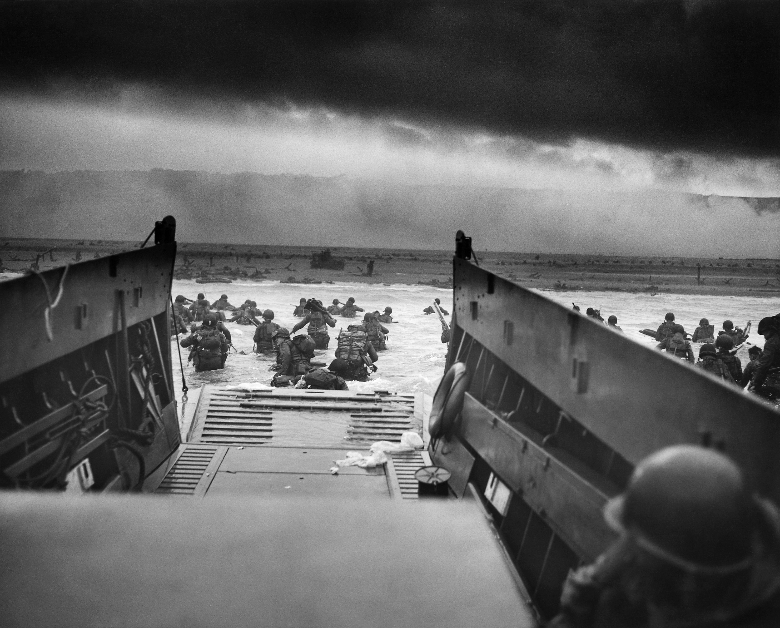American troops disembarking into the waters of Omaha Beach during the D-Day landings in Normandy, the start of the major Allied offensive in Western Europe.