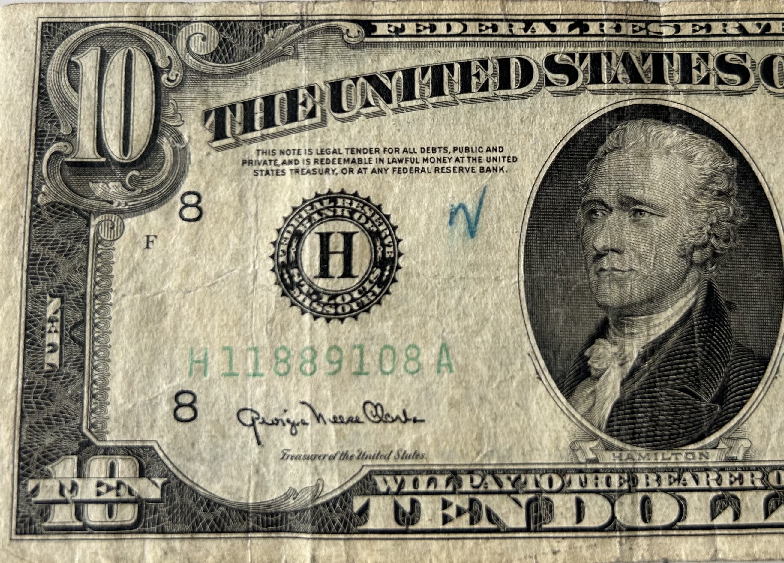 The "legal tender" declaration on a U.S. dollar bill demonstrates the mechanism of fiat currency, which derives its value from government decree and collective public trust rather than physical commodity backing.