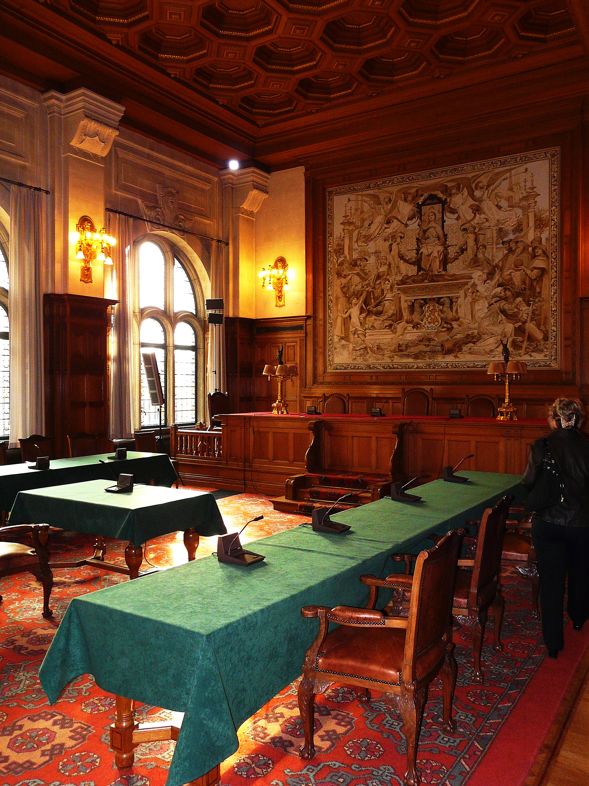 A hearing room of the Permanent Court of Arbitration — arbitration, like litigation, produces a binding decision, but through a private tribunal the parties themselves chose rather than a public court.