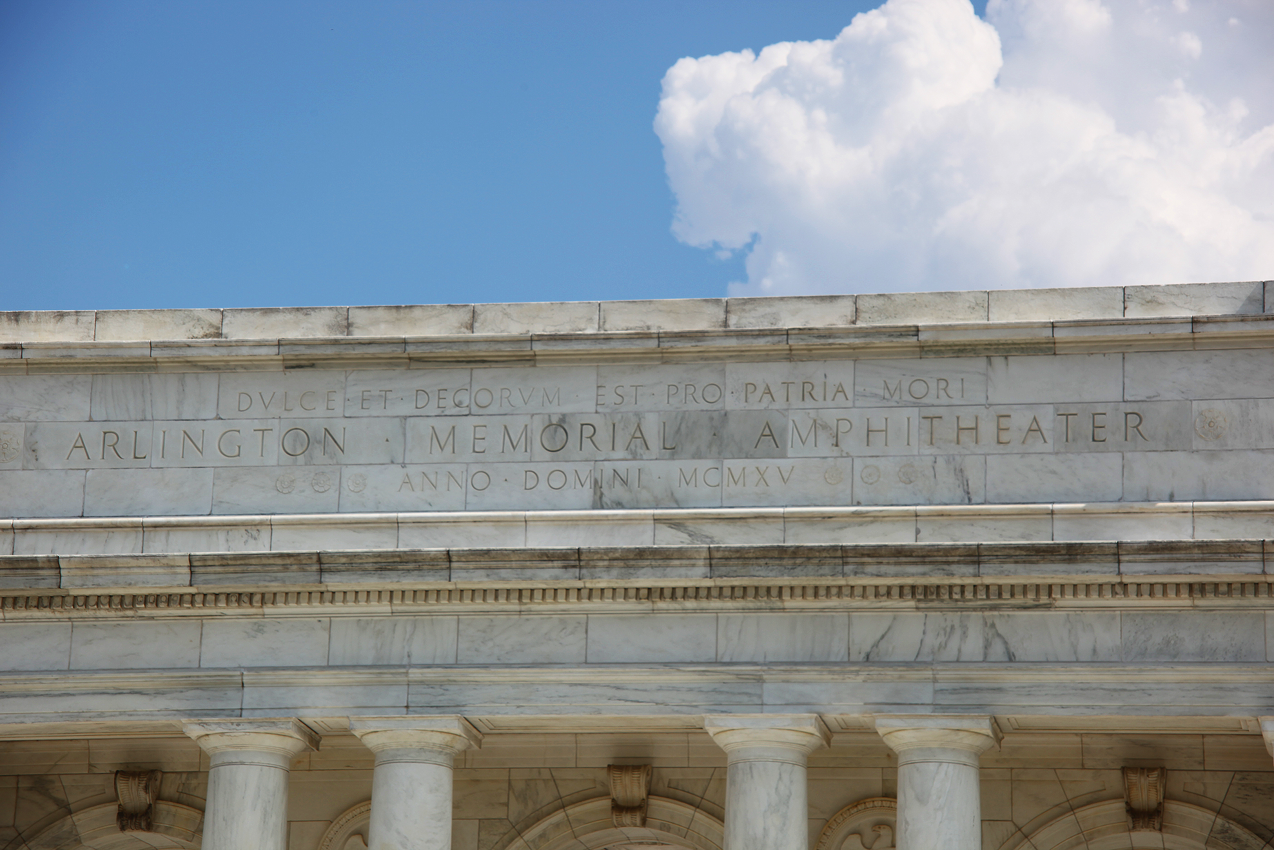An inscription at Arlington National Cemetery reading "Dulce et decorum est pro patria mori" (It is sweet and fitting to die for one's country). Wilfred Owen's famous poem directly attacks this specific sentiment to construct an opposing theme about the tragic reality of war.