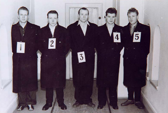 Fredrik Fasting Torgersen (centre) standing in a police identification lineup — the live, in-person format Code D calls an identification parade.