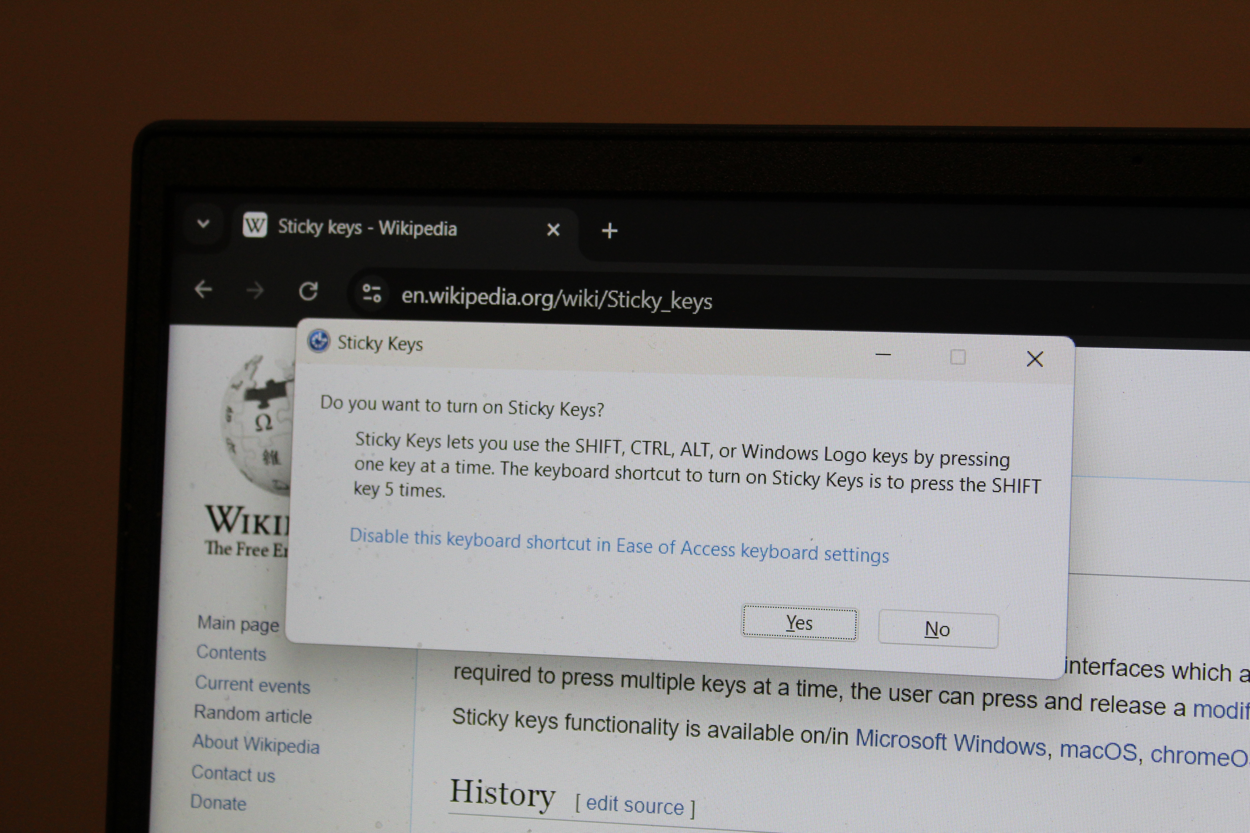 The Sticky Keys activation prompt in Windows. This is a critical accommodation allowing users with mobility impairments to sequence modifier keys rather than forcing them to hold multiple buttons simultaneously.