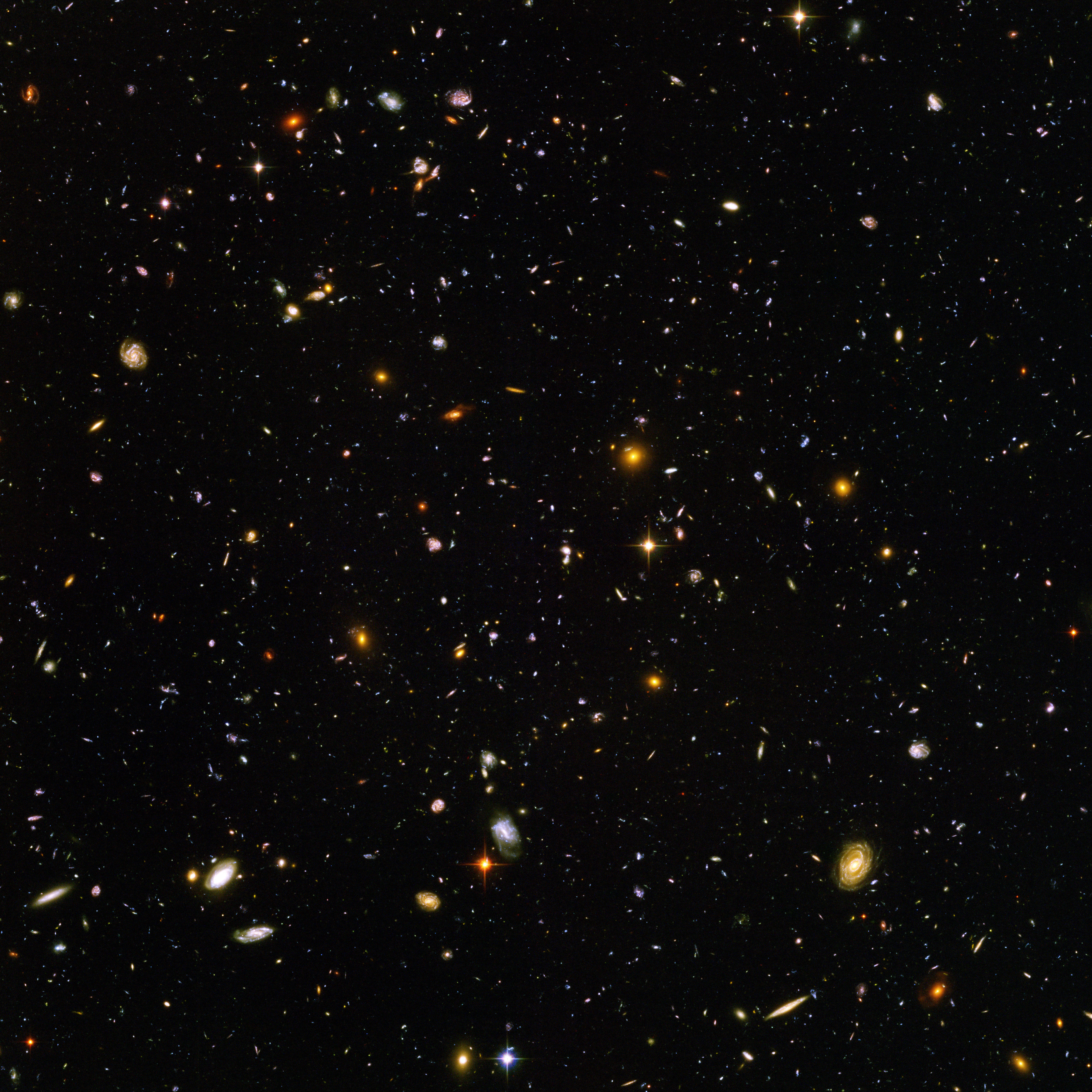 The sheer scale of the universe, from the subatomic to the astronomical distances seen in this deep-space image, necessitates the use of mathematical tools like exponents and scientific notation to compress and manage magnitudes.